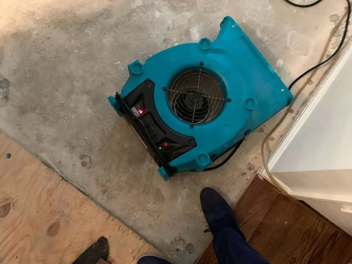 Air mover drying subfloor during Leak Detection & Repair in Simsbury